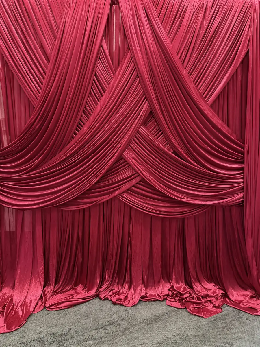 Burgundy draped backdrop installation