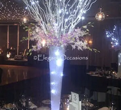 Tall glass Eiffel vase used as a reception table centrepiece