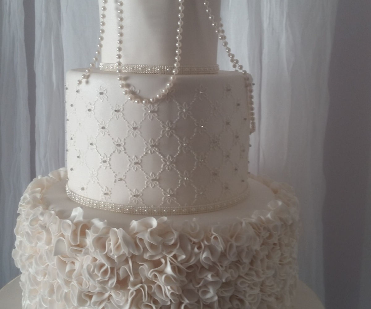 3 tier cake with pearls and lace