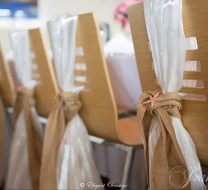 White chair cover finished with a tied sash for event seating