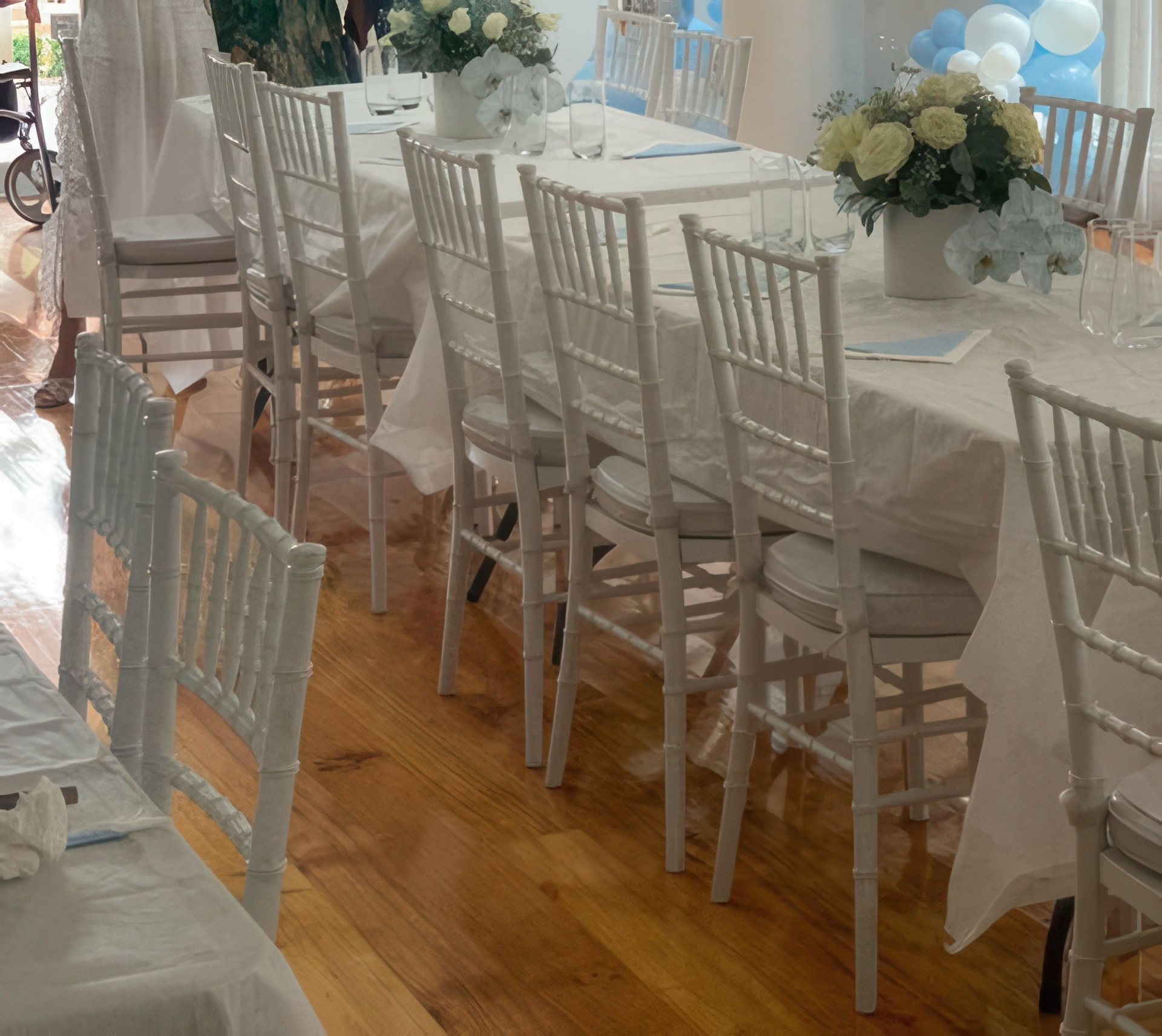 White Tiffany chair reception setting with florals