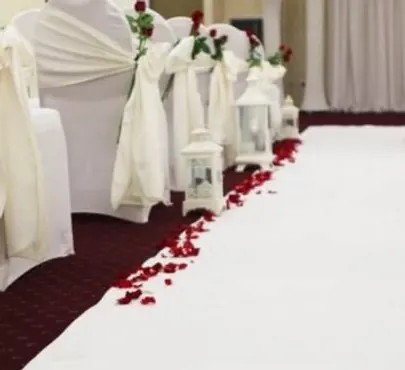 White Tiffany chairs arranged around a styled reception table
