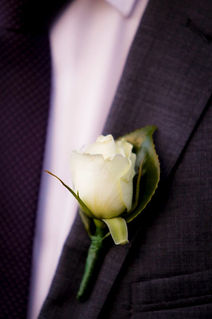 White rose buttonhole on suit lapel