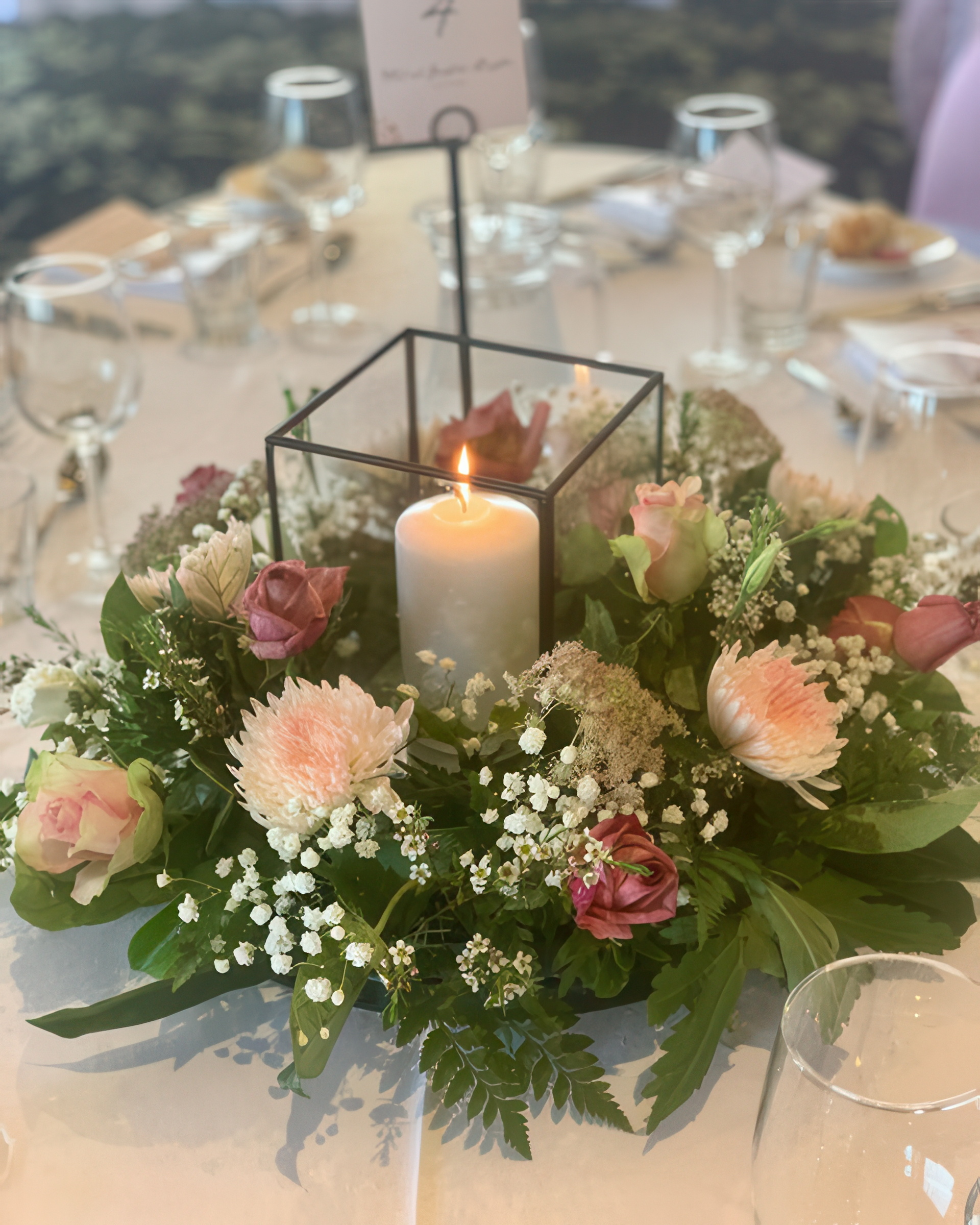 Tall floral centrepiece with green table accents