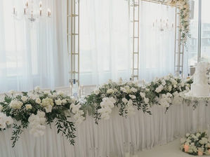 Gold backdrop with fabric and chandeliers